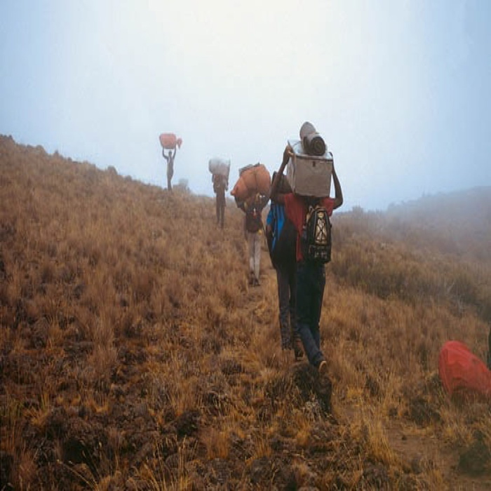042 Porters Ascending To The Saddle Through Cloud