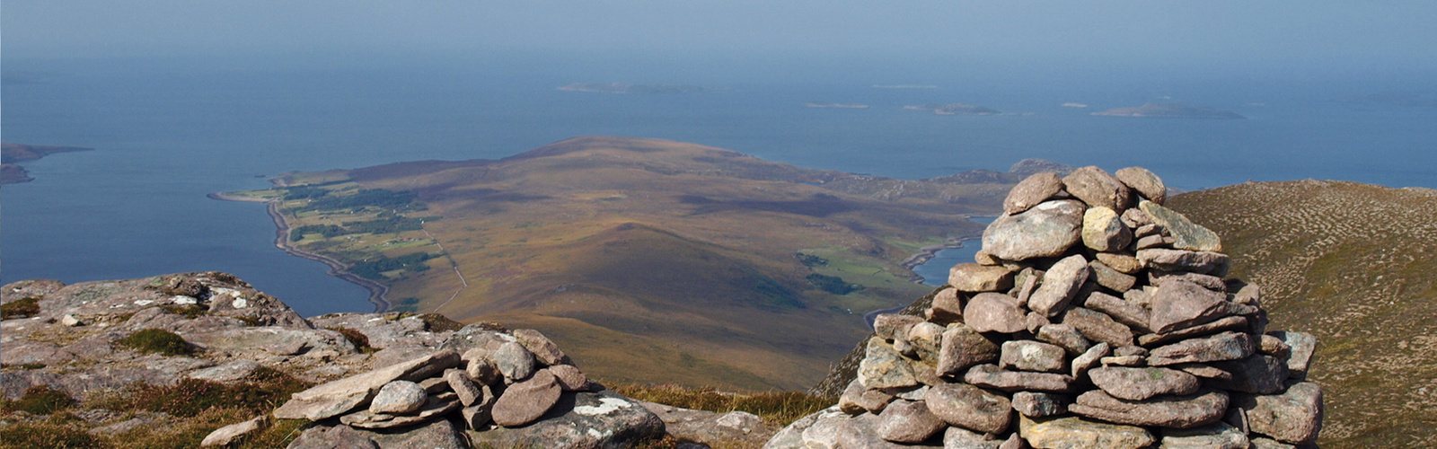 The summit of Beinn Ghobhlach with Scoraig peninsula beyond