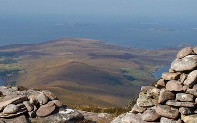 The summit of Beinn Ghobhlach with Scoraig peninsula beyond