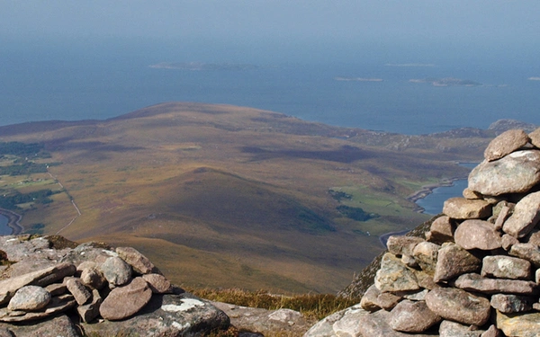 The summit of Beinn Ghobhlach with Scoraig peninsula beyond