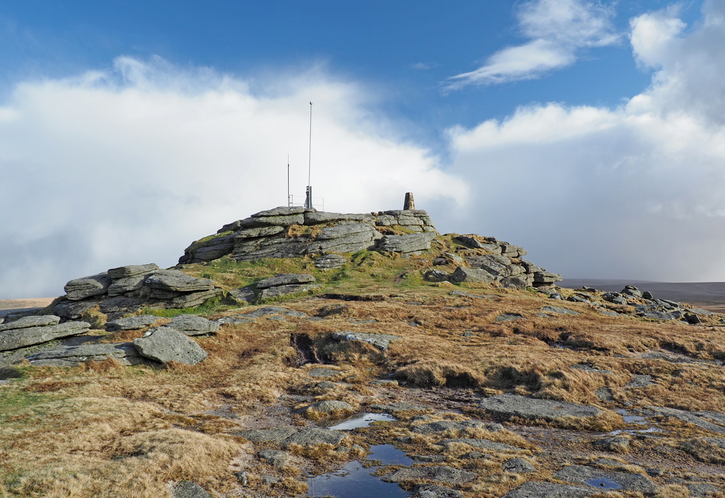 The summit of Yes Tor is crowned by a trig point and military flagpole​​​​​​​