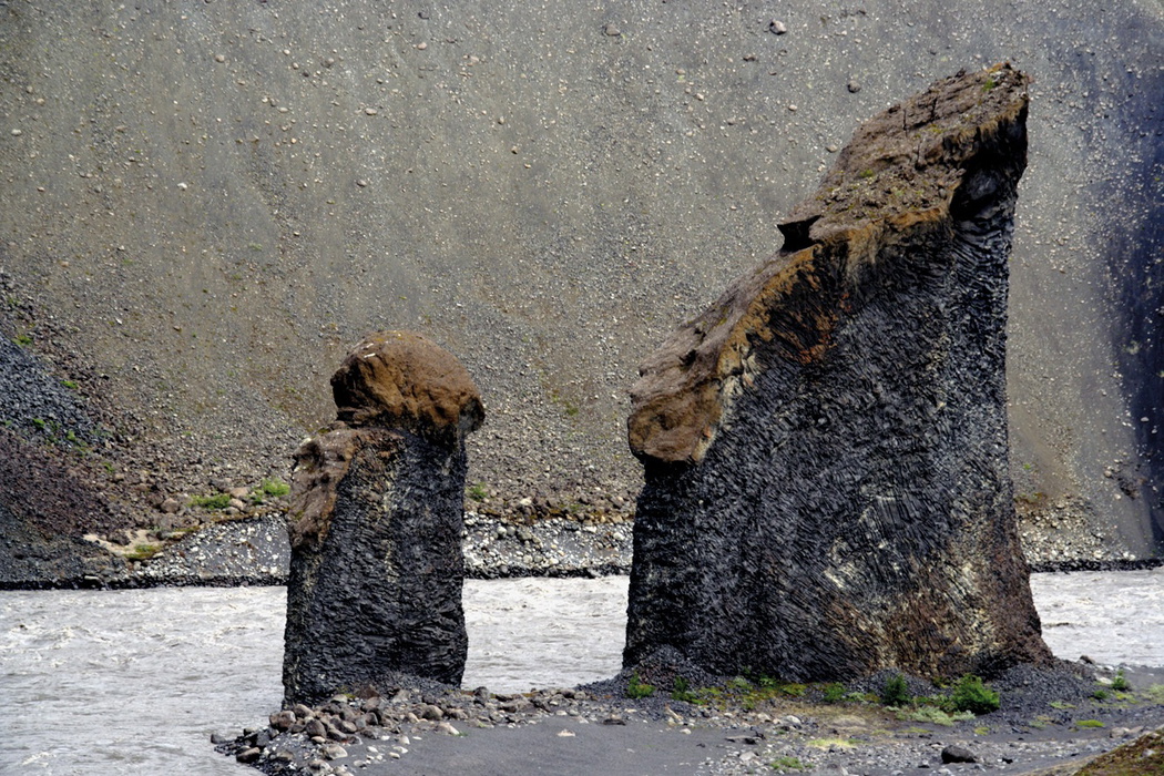 The twin rock towers of Karl og Kerling stand beside the river