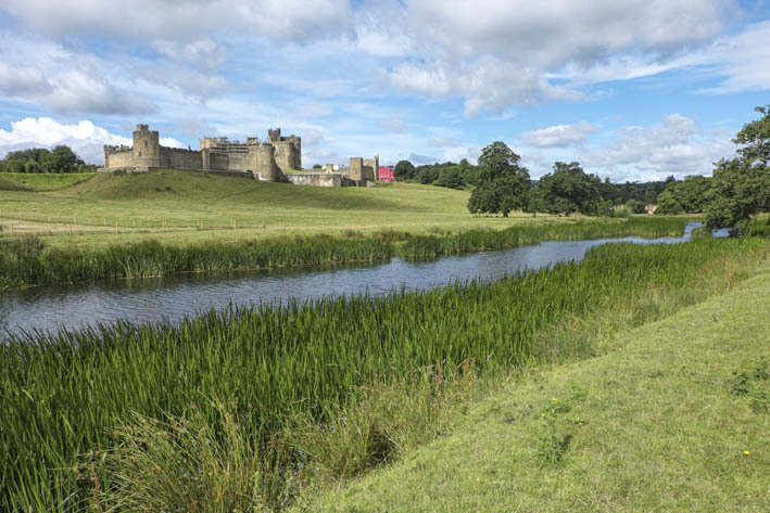 Alnwick Castle looms over the river