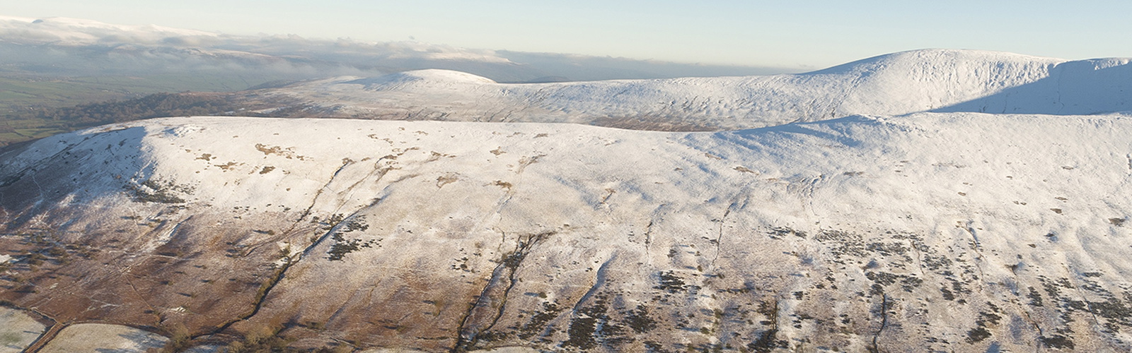 An aerial view from Bryn Teg of Cwm Cynwyn and Cefn Cyff, with the Black Mountains in the distance