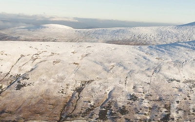 An aerial view from Bryn Teg of Cwm Cynwyn and Cefn Cyff, with the Black Mountains in the distance