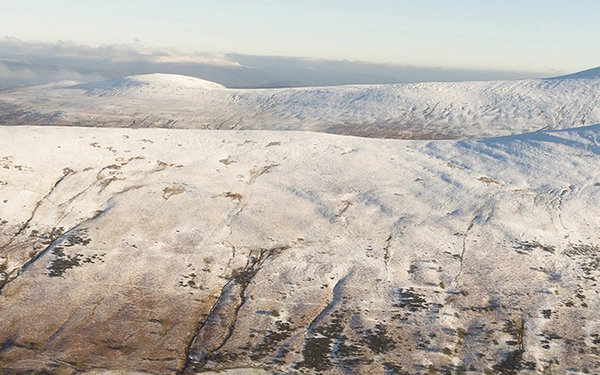 An aerial view from Bryn Teg of Cwm Cynwyn and Cefn Cyff, with the Black Mountains in the distance