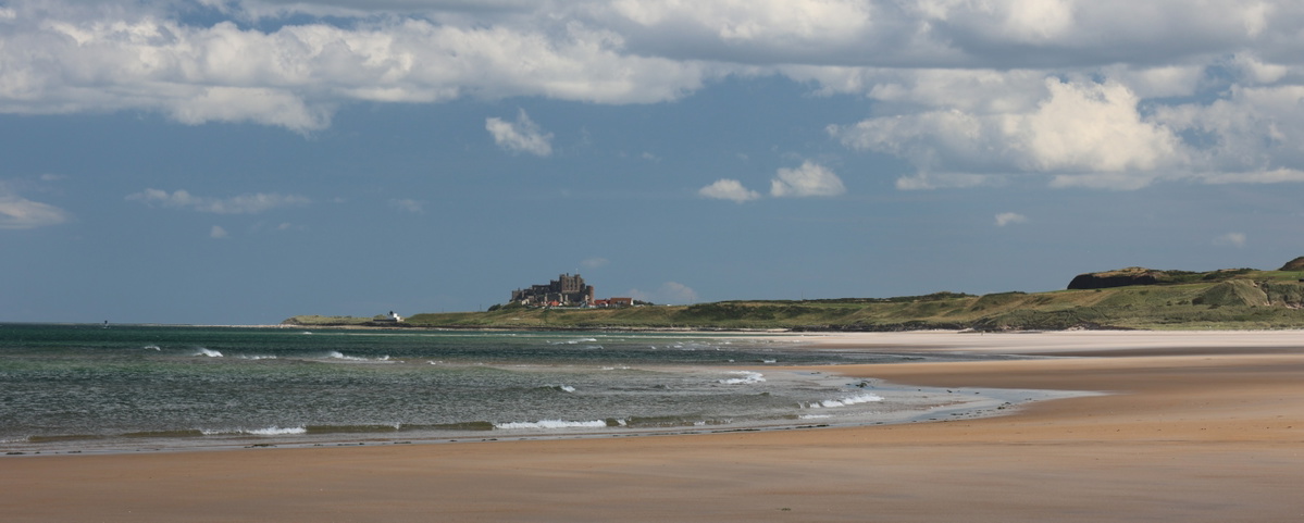 Bamburgh Castle from Ross Backs Sands, Northumberland, King Charles III England Coast Path